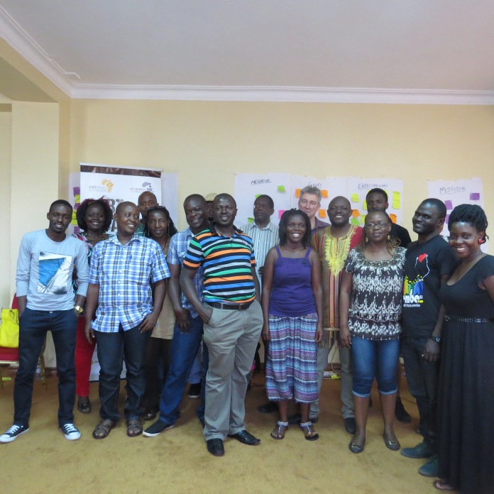 Participants and their trainers posing for a photo at the end of the workshop.